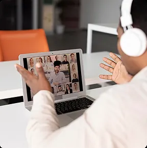 A speaker leading an online session with many participants