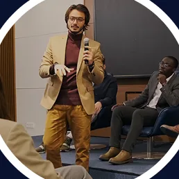 A speaker presenting to a seated audience